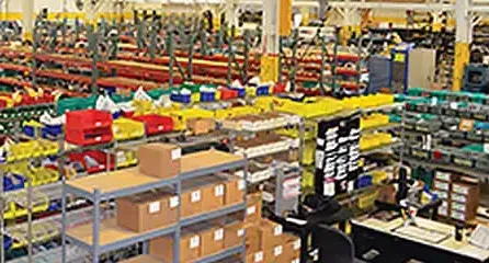 Warehouse shelves filled with boxes of parts